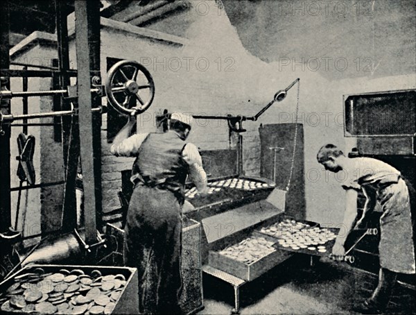 'Removing Biscuits from Oven', c1917. Artist: Unknown.