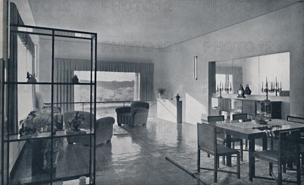 'Paniconi and Pediconi. A dining room with a large window and curtains designed to frame a beautiful Artist: Unknown.