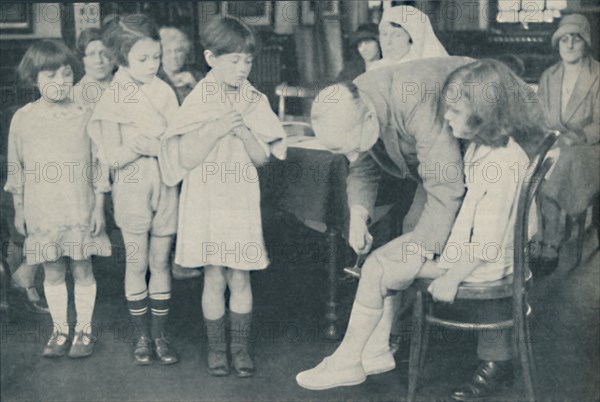 ' Testing the patella reflex for indication of nervous disease', c1935. Artist: Unknown.