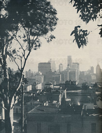 'Dwellings of Homely Timber in the Shadow of Concrete Giants', c1935. Artist: Unknown.