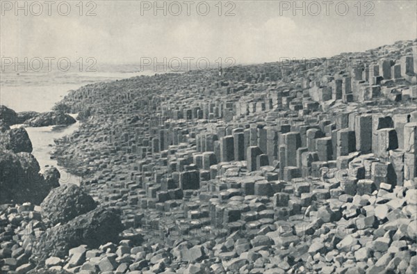 'Tessellated Promenade of the Grand Causeway Laid Down in Lava in the Far Distant Past', c1935. Artists: Unknown, W Lawrence.