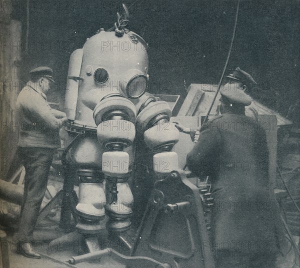 'Going Down at Short Notice: A British Diver Preparing To Seek a Submarine at Sea Bottom', c1935. Artist: Pacific and Atlantic.