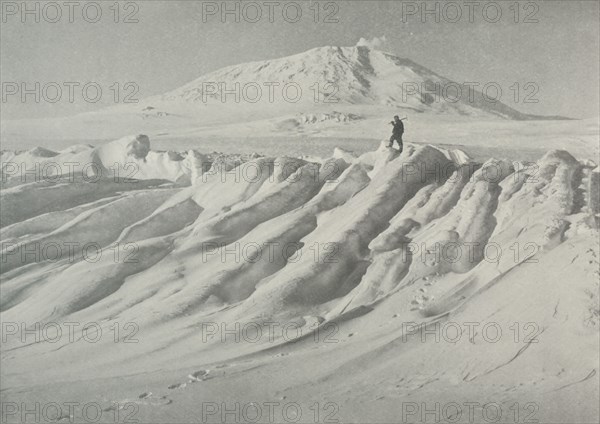 'Mount Erebus Over a Water-Worn Iceberg', October 1911, (1913). Artist: Herbert Ponting.