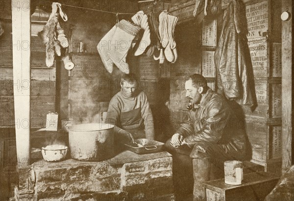 'Meares and Demetri at the Blubber Stove in the 'Discovery' Hut', 3 November 1911, (1913). Artist: Herbert Ponting.