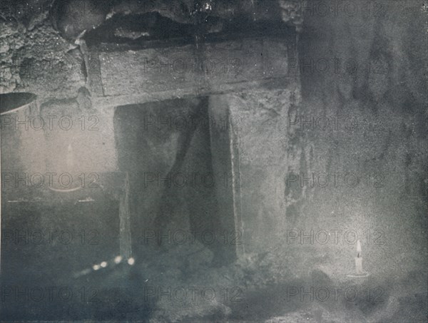 'Inside Door of Igloo by Light of Blubber Lamps', c1911, (1913). Artist: G Murray Levick.