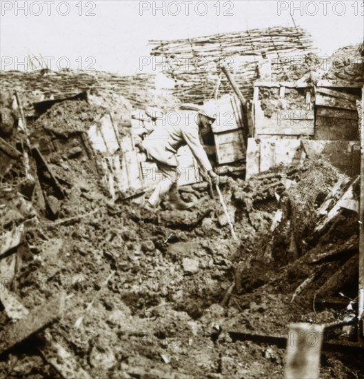 Aftermath of a shell, a soldier in the crater, c1914-c1918. Artist: Unknown.