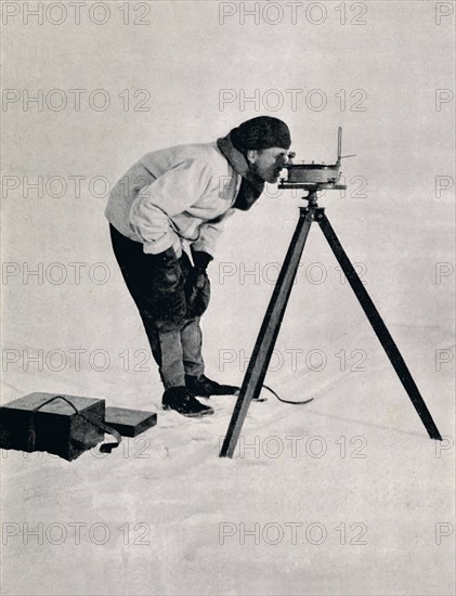 'Lieut. Pennell with a Prismatic Compass', December 1910, (1913). Artist: Herbert Ponting.