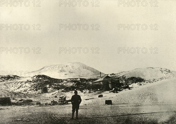 'The Hut, with Mount Erebus in the Background, in the Autumn', 1908, (1909).  Artist: Unknown.