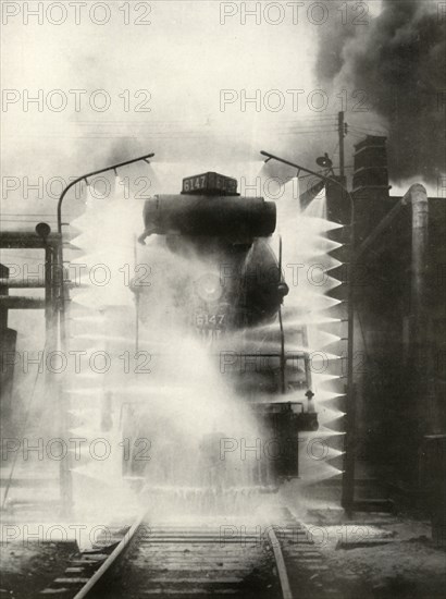 'Washing A Locomotive on the Canadian National Railway, at Montrea', 1935. Creator: Unknown.