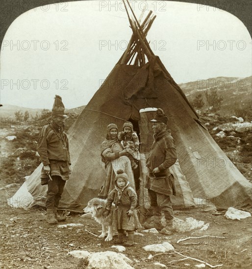 'Laplander family and sledge dog - outside their summer home - on a hillside in Norway', c1905. Creator: Unknown.