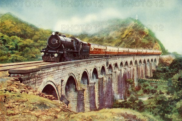 'Between Bombay and Delhi. A striking view of the Frontier Mail passing over a viaduct', 1935 Creator: Unknown.