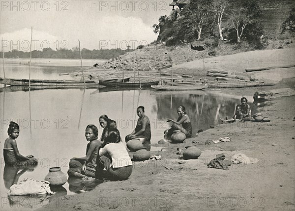 'Typical Riverside Scene on the great Irrawaddy - Women bathing and drawing water', 1900. Creator: Unknown.