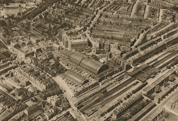 'Over Olympia and the Headquarters of the Post Office Savings Bank', c1935. Creator: Surrey Flying Services.