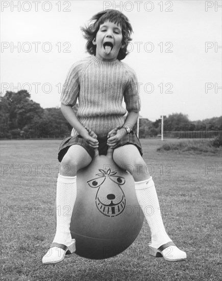 Girl on a space hopper, 1970s.