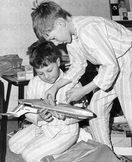 Boys playing with a model plane, c1960s.