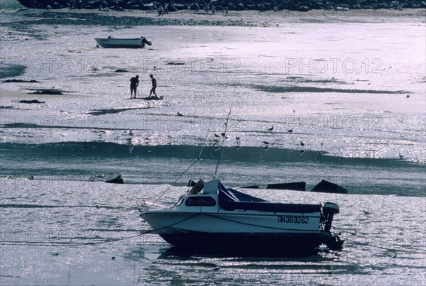 Boat at low tide, Port-en-Bessin, Normandy, France.