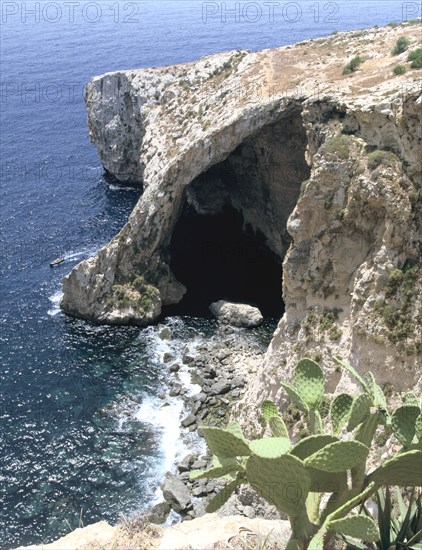 View of natural bridge and boat, Blue Grotto, Malta