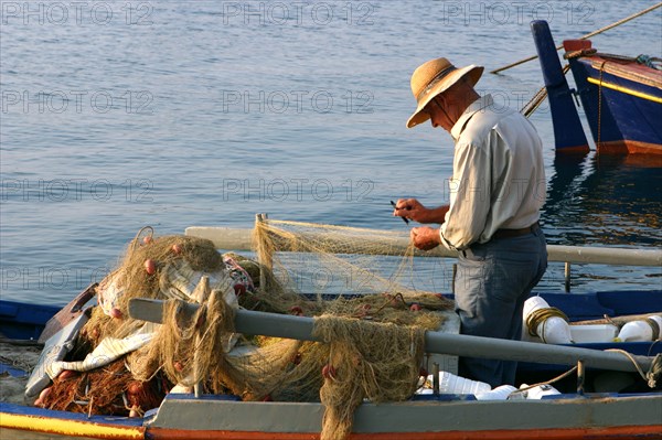 Man on board a fishing boat, Sami, Kefalonia, Greece