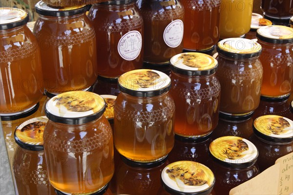 Jars of honey on a market stall, Mallorca, Spain.