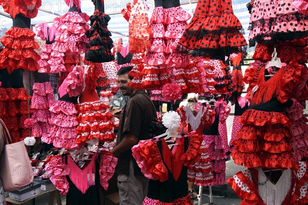 Colourful flamenco dresses for sale in a market, Mallorca, Spain.