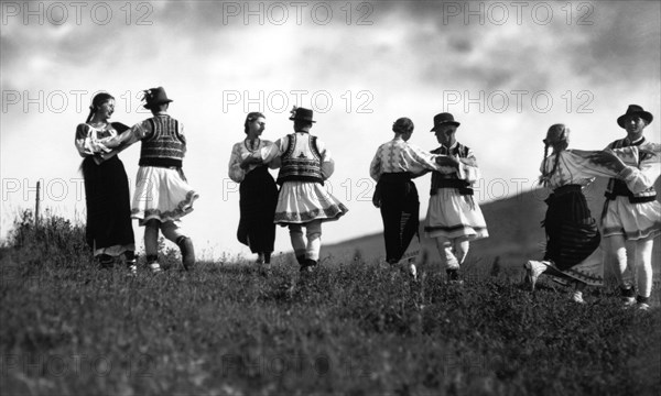 Couples in traditional dress dancing, Bistrita Valley, Moldavia, north-east Romania, c1920-c1945. Artist: Adolph Chevalier