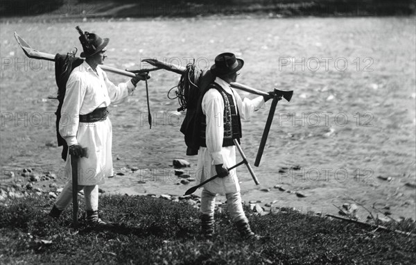 Foresters carrying their tools, Bistrita Valley, Moldavia, north-east Romania, c1920-c1945. Artist: Adolph Chevalier