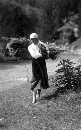 Woman carrying a bundle of sticks, Bistrita Valley, Moldavia, north-east Romania, c1920-c1945. Artist: Adolph Chevalier
