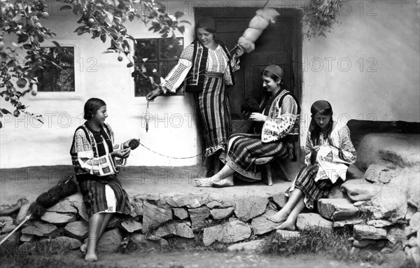 Young women spinning and sewing, Bistrita Valley, Moldavia, north-east Romania, c1920-c1945. Artist: Adolph Chevalier