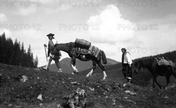 Man and woman leading horses, Bistrita Valley, Moldavia, north-east Romania, c1920-c1945. Artist: Adolph Chevalier