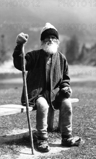 Old man sitting on a bench, Bistrita Valley, Moldavia, north-east Romania, c1920-c1945. Artist: Adolph Chevalier