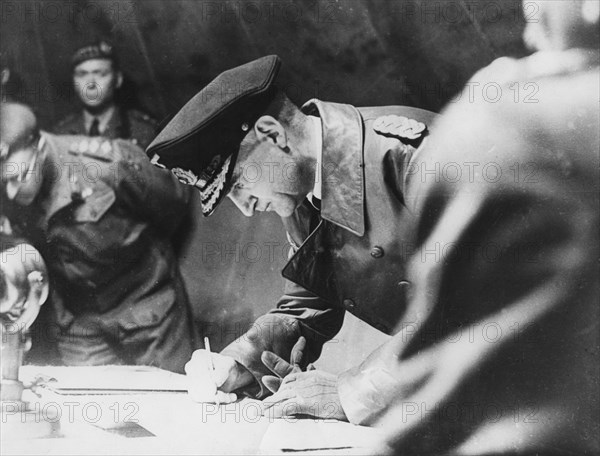 Rear-Admiral Gerhard Wagner signing the German surrender document ending World War II, 1945. Artist: Unknown