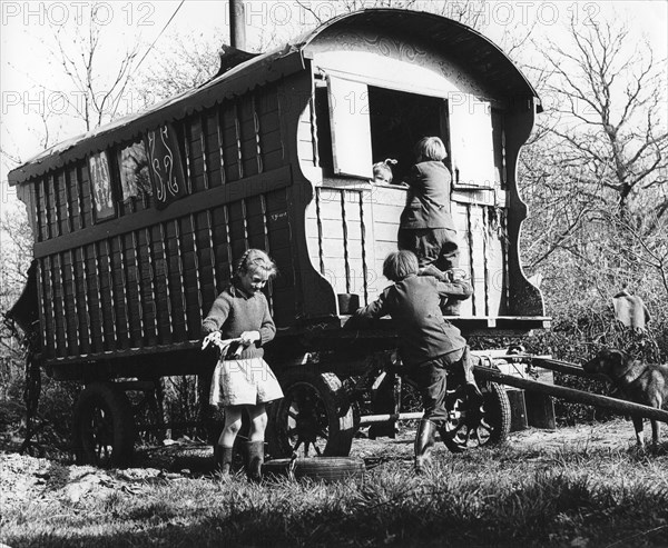 Gypsy children playing outside their caravan, 1960s.