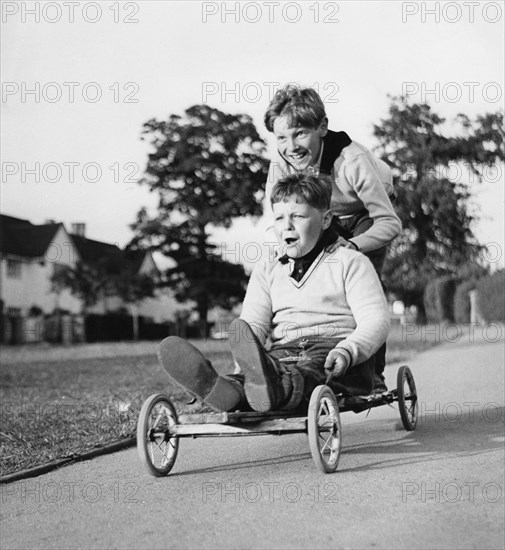 Boys playing with a home-made go-kart, Horley, Surrey, 1965.