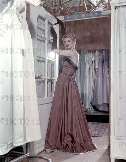 Female model shows an evening dress, Stockholm, 1950s. Artist: Göran Algård