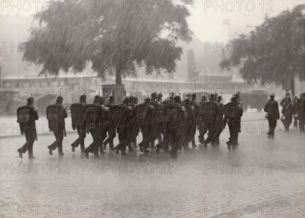 Soldiers returning to their base in a cloudburst, Stockholm, Sweden, 1934. Artist: Karl Sandels