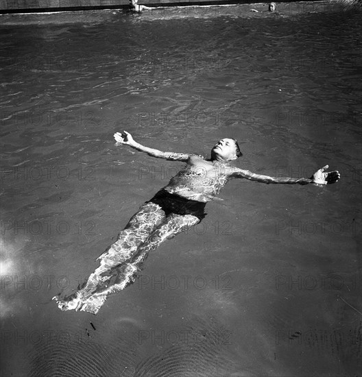 A man takes a refreshing dip in a swimming pool during the hot summer, Sweden, 1943. Artist: Karl Sandels