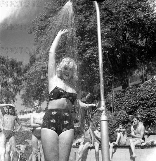 A refreshing shower during the heatwave in Stockholm, Sweden, 24th July 1943. Artist: Karl Sandels