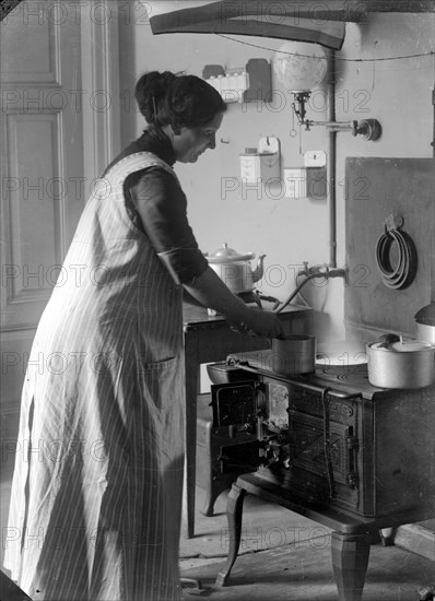 The photographer's wife in the kitchen, Landskrona, Sweden, 1910. Artist: Unknown