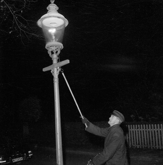 Lighting a gas lantern. Landskrona, Sweden, 1956. Artist: Unknown