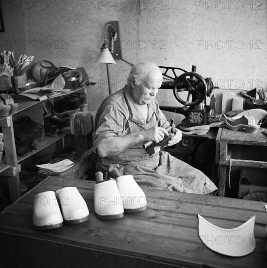 Making wooden clogs, Sweden. Artist: Unknown