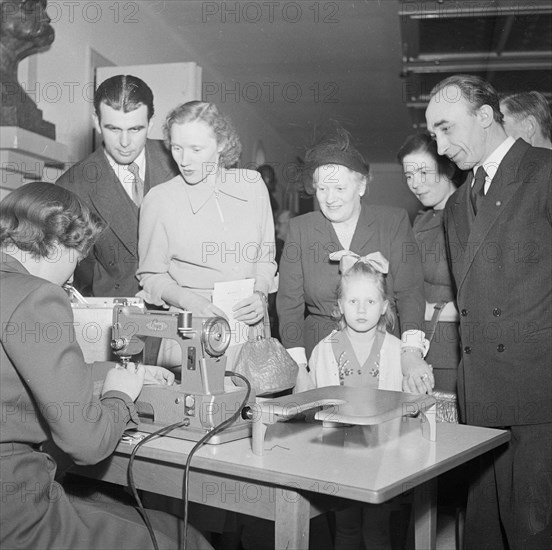 A woman demonstrates a sewing machine, Landskrona, Sweden, 1951. Artist: Unknown