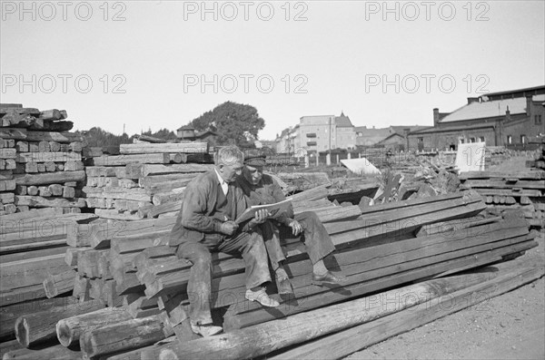 Two men in a woodyard, Landskrona, Sweden, 1935. Artist: Unknown