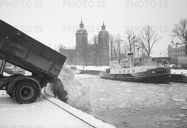 The snow clearance squad tip snow into the harbour, Landskrona, Sweden 1958. Artist: Unknown