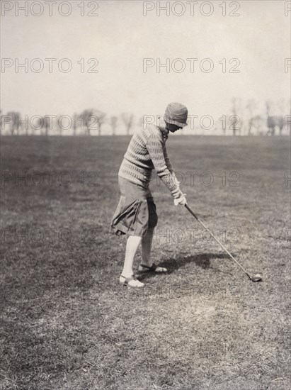 A lady golfer playing at Falsterbo Colf Club, Sweden. Artist: Otto Ohm