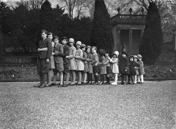 Cavendish family group of 16 grandchildren in the gardens of Chatsworth, Derbyshire, Christmas 1929. Artist: JR Board