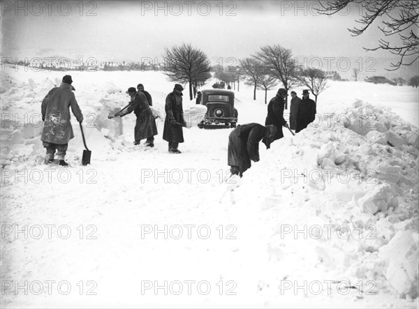 German/Italian prisoners of war clearing snow on Fairfield Common, Buxton, Derbyshire, 1947. Artist: JD Meddins