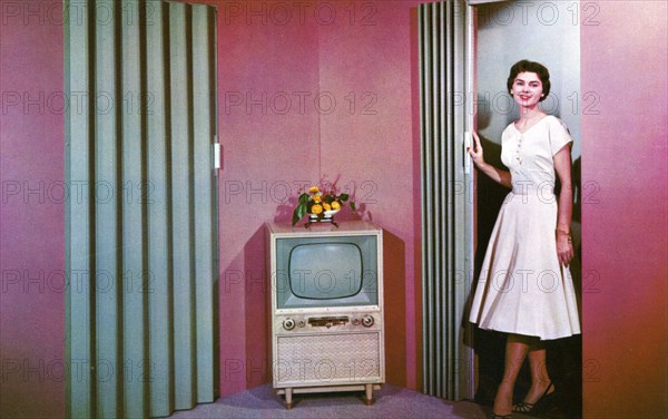 Woman walking into a room with a television, Janesville, Wisconsin, USA, 1955. Artist: Unknown