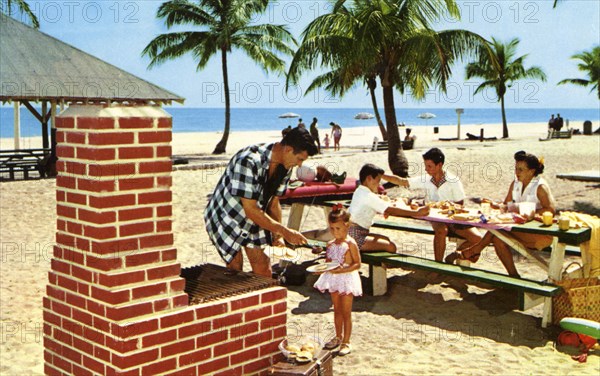 A family enjoying a picnic and barbecue on a sandy beach in Florida, USA, 1957. Artist: Unknown