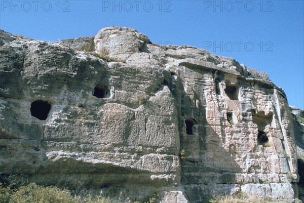 Assyrian rock reliefs pitted by Chr hermit caves, Bavian, Iraq, 1977.