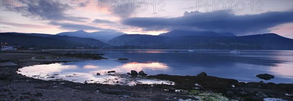 View across Brodick Bay to Beinn Tarsuinn and Goatfell at sunset, Arran, North Ayrshire, Scotland.